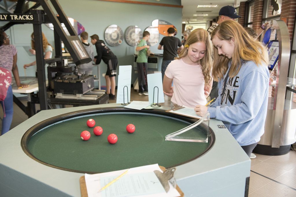 Students reading and getting hands-on with exhibits in the Methods Room. 